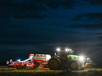 FONTENAY-LE-PESNEL, FRANCE - OCTOBER 11: 
A tractor John Deere 6250R pulls the AEROSEM POTTINGER pneumatic seed drill through a field near F...