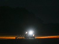 FONTENAY-LE-PESNEL, FRANCE - OCTOBER 11: 
A tractor plows the field with a heavy plough on an October night near Fontenay-le-Pesnel, Calvado...