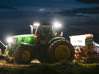 FONTENAY-LE-PESNEL, FRANCE - OCTOBER 11: 
A tractor John Deere 6250R pulls the AEROSEM POTTINGER pneumatic seed drill through a field near F...