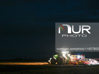 FONTENAY-LE-PESNEL, FRANCE - OCTOBER 11: 
A tractor John Deere 6250R pulls the AEROSEM POTTINGER pneumatic seed drill through a field near F...