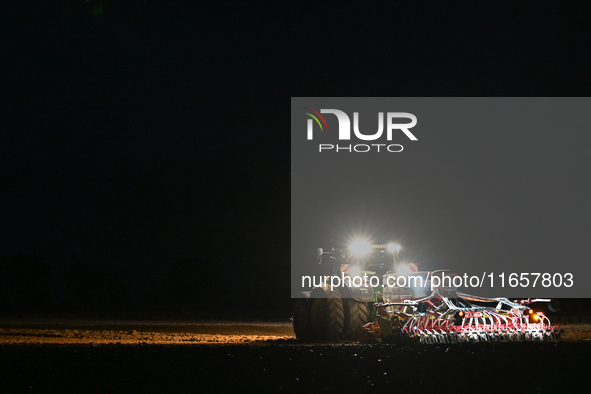 FONTENAY-LE-PESNEL, FRANCE - OCTOBER 11: 
A tractor John Deere 6250R pulls the AEROSEM POTTINGER pneumatic seed drill through a field near F...