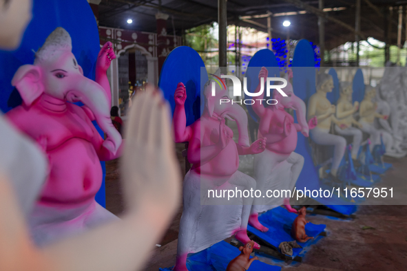 Artisans prepare idols of Lord Ganesha in vibrant shades of pink and blue for the Sharadiya Durga Puja festival in Bangladesh. Their detaile...