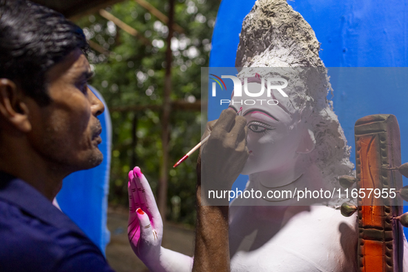 An artisan works on an idol of the Hindu goddess Durga at a workshop ahead of the Durga Puja festival in Dhaka, Bangladesh, on October 4, 20...