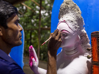 An artisan works on an idol of the Hindu goddess Durga at a workshop ahead of the Durga Puja festival in Dhaka, Bangladesh, on October 4, 20...