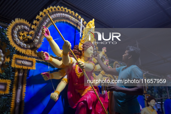 An artisan works on an idol of the Hindu goddess Durga at a workshop ahead of the Durga Puja festival in Dhaka, Bangladesh, on October 4, 20...