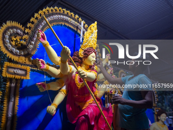 An artisan works on an idol of the Hindu goddess Durga at a workshop ahead of the Durga Puja festival in Dhaka, Bangladesh, on October 4, 20...