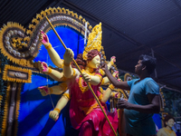 An artisan works on an idol of the Hindu goddess Durga at a workshop ahead of the Durga Puja festival in Dhaka, Bangladesh, on October 4, 20...