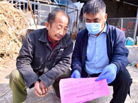 A staff member of a livestock station in Quanzhen town propagates knowledge about animal and poultry epidemic prevention to farmers in Damaw...