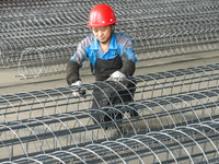 A worker makes concrete pipe pile products in Huzhou, China, on October 12, 2024. (