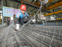 A worker makes concrete pipe pile products in Huzhou, China, on October 12, 2024. (