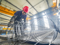 A worker makes concrete pipe pile products in Huzhou, China, on October 12, 2024. (