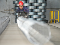 A worker makes concrete pipe pile products in Huzhou, China, on October 12, 2024. (