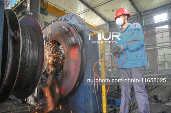 A worker makes concrete pipe pile products in Huzhou, China, on October 12, 2024. 