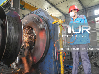 A worker makes concrete pipe pile products in Huzhou, China, on October 12, 2024. (