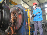 A worker makes concrete pipe pile products in Huzhou, China, on October 12, 2024. (