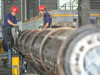 A worker makes concrete pipe pile products in Huzhou, China, on October 12, 2024. (