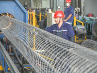 A worker makes concrete pipe pile products in Huzhou, China, on October 12, 2024. (