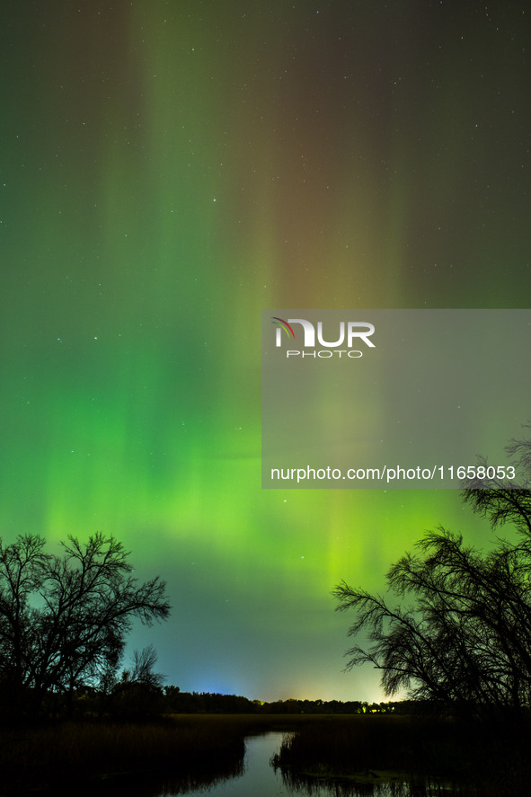 The Aurora Borealis, or Northern Lights, is visible over Chisago City, Minnesota, due to a major geomagnetic storm and heightened solar acti...