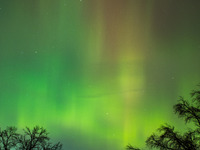 The Aurora Borealis, or Northern Lights, is visible over Chisago City, Minnesota, due to a major geomagnetic storm and heightened solar acti...