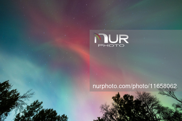 The Aurora Borealis, or Northern Lights, is visible over Chisago City, Minnesota, due to a major geomagnetic storm and heightened solar acti...