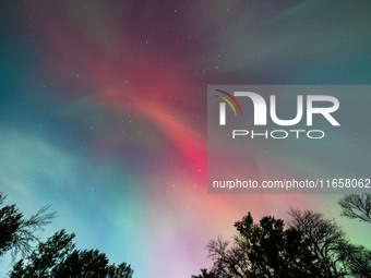 The Aurora Borealis, or Northern Lights, is visible over Chisago City, Minnesota, due to a major geomagnetic storm and heightened solar acti...