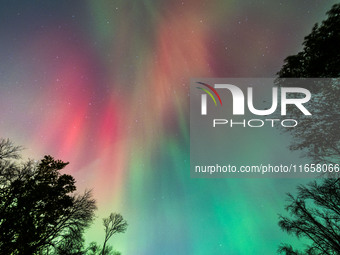 The Aurora Borealis, or Northern Lights, is visible over Chisago City, Minnesota, due to a major geomagnetic storm and heightened solar acti...