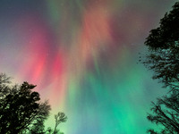 The Aurora Borealis, or Northern Lights, is visible over Chisago City, Minnesota, due to a major geomagnetic storm and heightened solar acti...