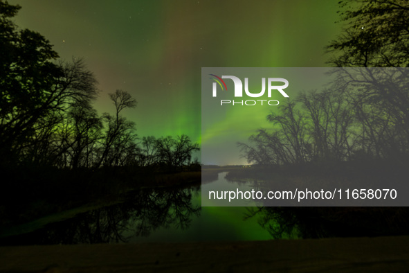 The Aurora Borealis, or Northern Lights, is visible over Chisago City, Minnesota, due to a major geomagnetic storm and heightened solar acti...