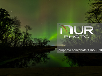 The Aurora Borealis, or Northern Lights, is visible over Chisago City, Minnesota, due to a major geomagnetic storm and heightened solar acti...