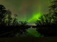 The Aurora Borealis, or Northern Lights, is visible over Chisago City, Minnesota, due to a major geomagnetic storm and heightened solar acti...