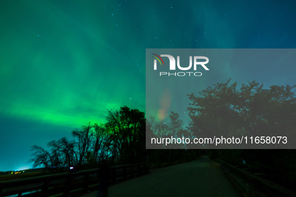 The Aurora Borealis, or Northern Lights, is visible over Chisago City, Minnesota, due to a major geomagnetic storm and heightened solar acti...