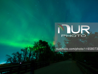 The Aurora Borealis, or Northern Lights, is visible over Chisago City, Minnesota, due to a major geomagnetic storm and heightened solar acti...