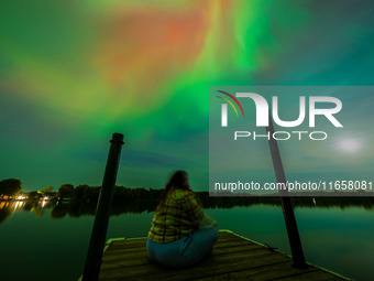 The Aurora Borealis, or Northern Lights, is visible over Chisago City, Minnesota, due to a major geomagnetic storm and heightened solar acti...