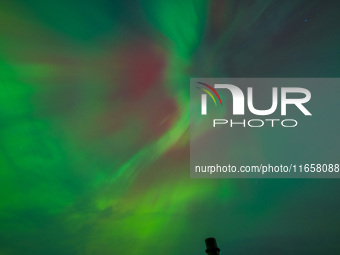 The Aurora Borealis, or Northern Lights, is visible over Chisago City, Minnesota, due to a major geomagnetic storm and heightened solar acti...