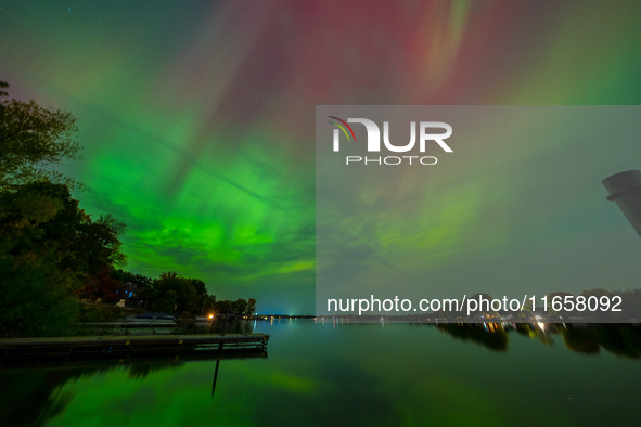 The Aurora Borealis, or Northern Lights, is visible over Chisago City, Minnesota, due to a major geomagnetic storm and heightened solar acti...