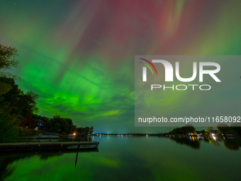 The Aurora Borealis, or Northern Lights, is visible over Chisago City, Minnesota, due to a major geomagnetic storm and heightened solar acti...