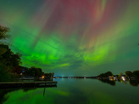 The Aurora Borealis, or Northern Lights, is visible over Chisago City, Minnesota, due to a major geomagnetic storm and heightened solar acti...