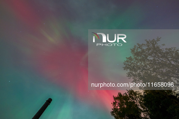 The Aurora Borealis, or Northern Lights, is visible over Chisago City, Minnesota, due to a major geomagnetic storm and heightened solar acti...