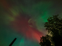 The Aurora Borealis, or Northern Lights, is visible over Chisago City, Minnesota, due to a major geomagnetic storm and heightened solar acti...