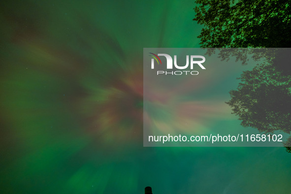 The Aurora Borealis, or Northern Lights, is visible over Chisago City, Minnesota, due to a major geomagnetic storm and heightened solar acti...