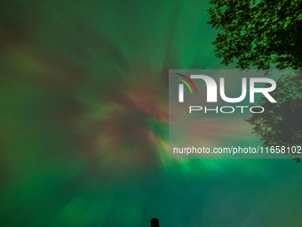 The Aurora Borealis, or Northern Lights, is visible over Chisago City, Minnesota, due to a major geomagnetic storm and heightened solar acti...