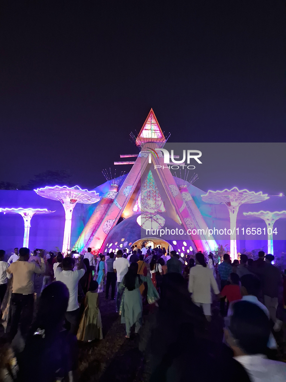 Devotees visit the puja pandal where the idol of Hindu Goddess 'Durga' is worshiped during the Durga Puja festival celebrations in Siliguri,...