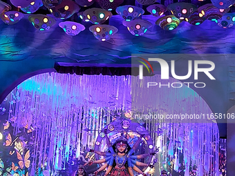 Devotees visit the puja pandal where the idol of Hindu Goddess 'Durga' is worshiped during the Durga Puja festival celebrations in Siliguri,...