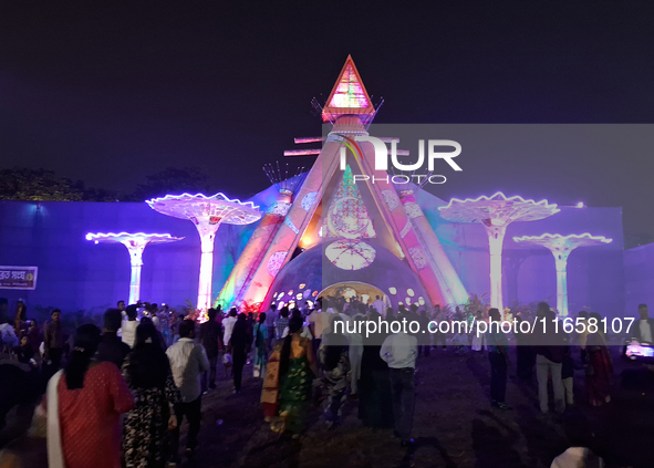 Devotees visit the puja pandal where the idol of Hindu Goddess 'Durga' is worshiped during the Durga Puja festival celebrations in Siliguri,...