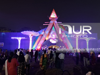 Devotees visit the puja pandal where the idol of Hindu Goddess 'Durga' is worshiped during the Durga Puja festival celebrations in Siliguri,...