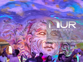 Devotees visit the puja pandal where the idol of Hindu Goddess 'Durga' is worshiped during the Durga Puja festival celebrations in Siliguri,...