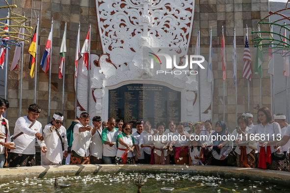 Relatives of the victims of the 2002 Bali bombings tragedy throw flowers in front of the Bali Bombing Memorial during the 22nd commemoration...