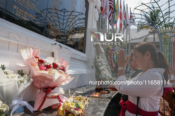 Relatives of the victims of the 2002 Bali bombings pray in front of the Bali Bombing Memorial during the 22nd commemoration of the attacks i...