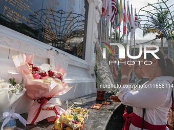 Relatives of the victims of the 2002 Bali bombings pray in front of the Bali Bombing Memorial during the 22nd commemoration of the attacks i...