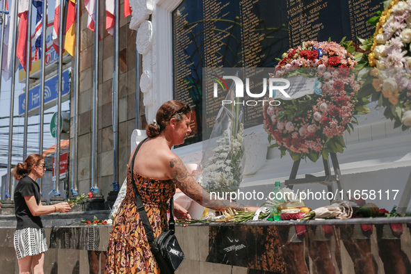 Tourists lay flowers at the Bali Bombing Memorial during the 22nd commemoration of the 2002 Bali bombing tragedy in Kuta, Bali, Indonesia, o...